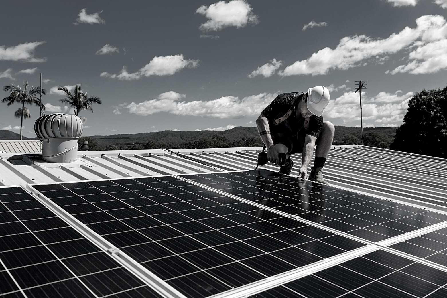 Solar Panel Technician with Drill Installing Solar Panels